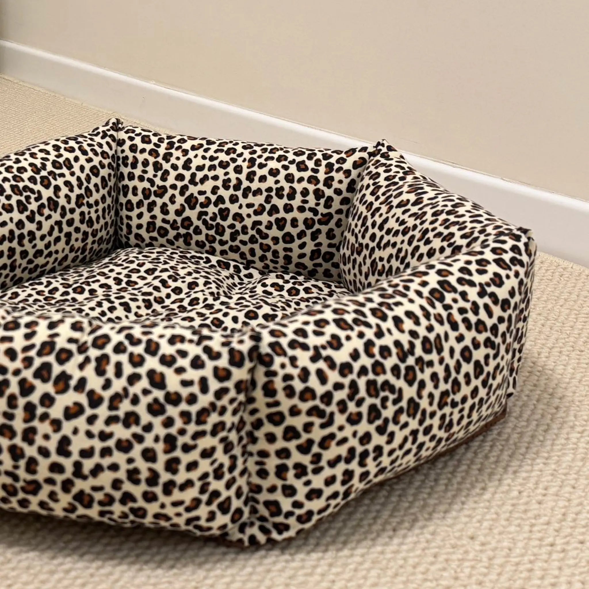 Leopard print pet bed on a neutral background