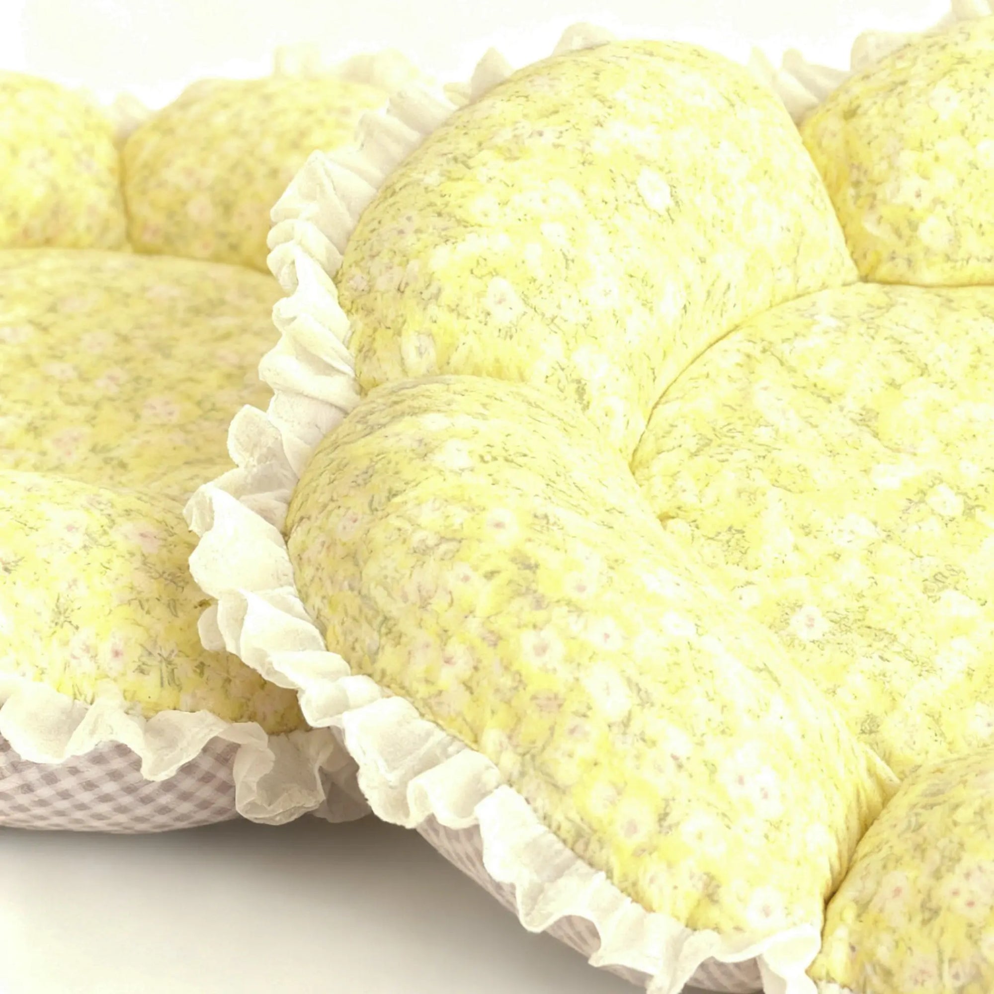 Close-up of soft cotton fabric with yellow flower print on cat bed