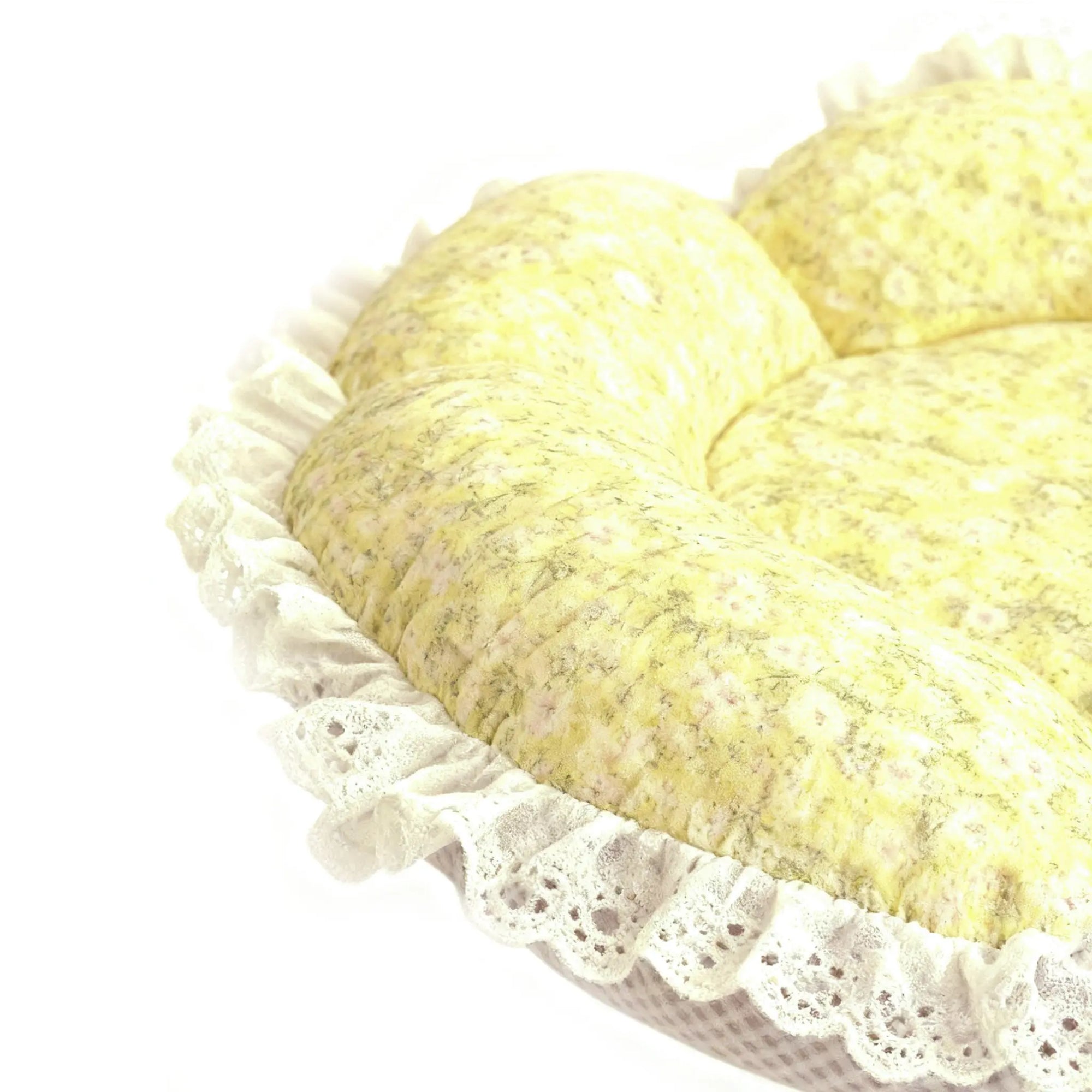 Detail view of stitching and plush texture of yellow floral cat bed for cats